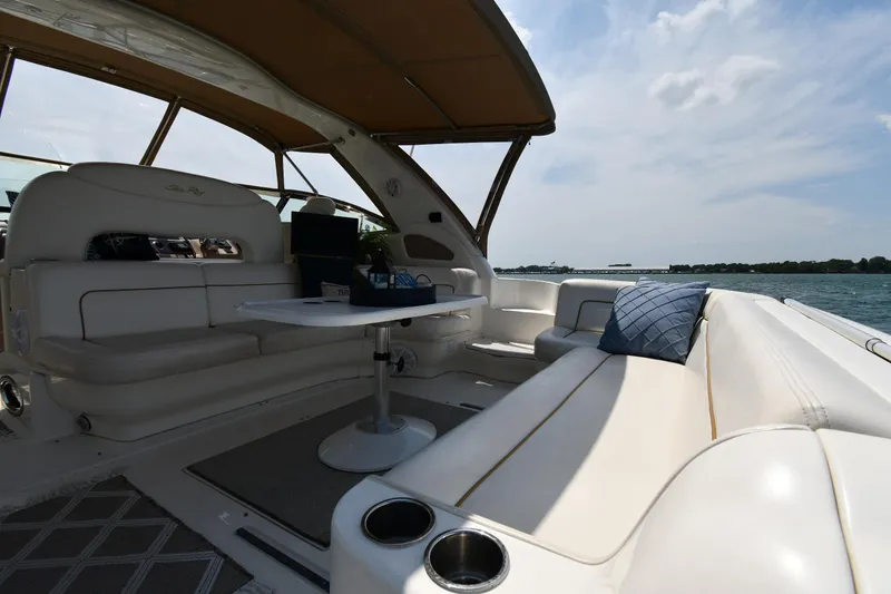 Slide: The Image of The image shows the cockpit of a 2000 Sea Ray Sundancer 460 with white seating. - 25