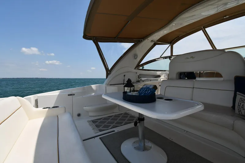 Slide: The Image of The image shows the cockpit of a 2000 Sea Ray Sundancer 460 on the water. - 27