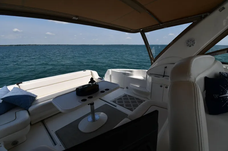 Slide: The Image of The image shows the cockpit of a 2000 Sea Ray Sundancer 460 overlooking the sea. - 31