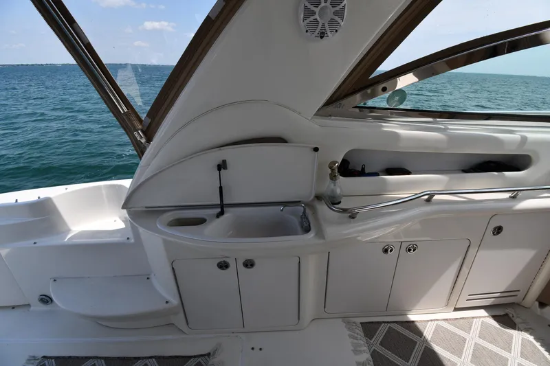 Slide: The Image of The image shows the cockpit of a 2000 Sea Ray Sundancer 460 with a view of the sea. - 32