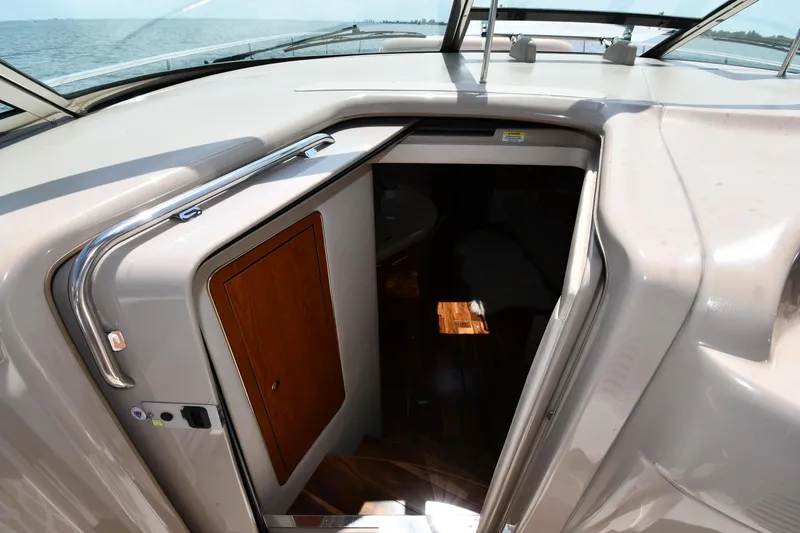 Slide: The Image of The 2000 Sea Ray Sundancer 460 features a cabin entrance with a wooden door and stairs. - 34