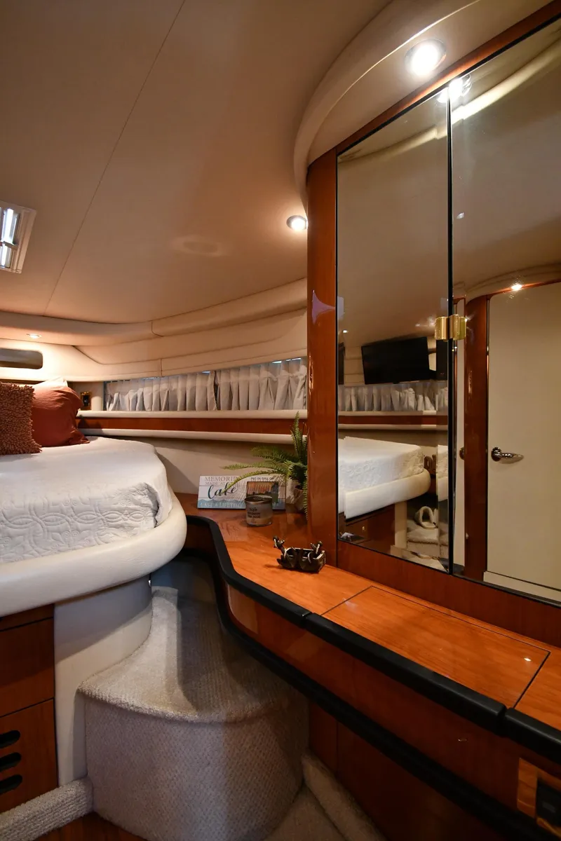 Slide: The Image of Interior of a 2000 Sea Ray Sundancer 460 with cozy bed and wood paneling. - 37