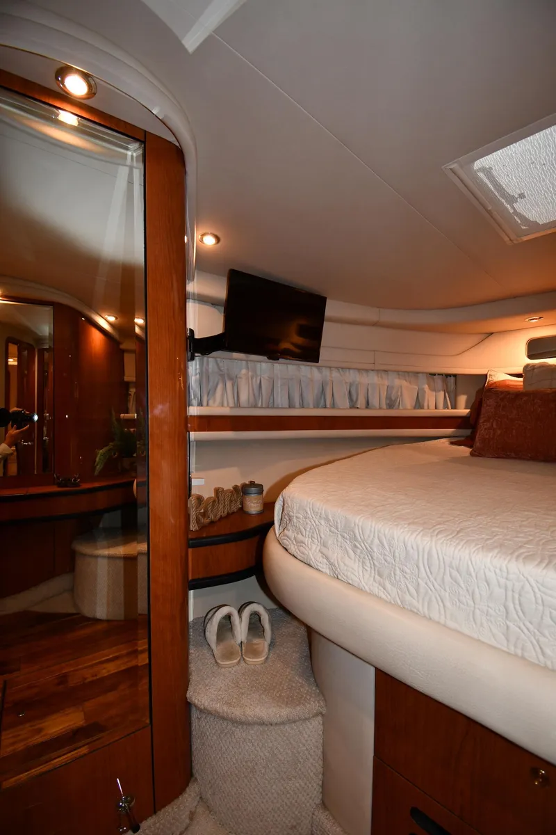 Slide: The Image of Interior of a 2000 Sea Ray Sundancer 460 with cozy bedroom and wood accents. - 38