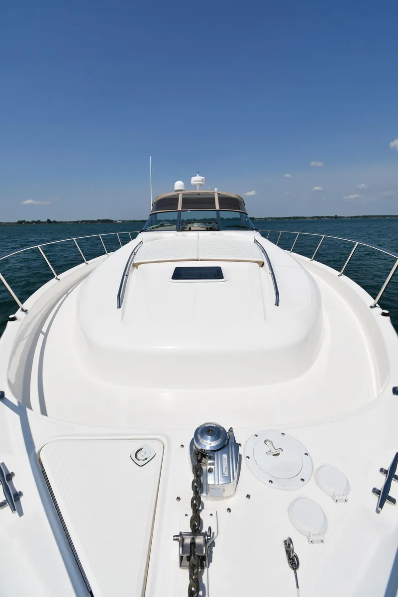 Slide: The Image of A 2000 Sea Ray Sundancer 460 on calm water with a clear sky. - 4