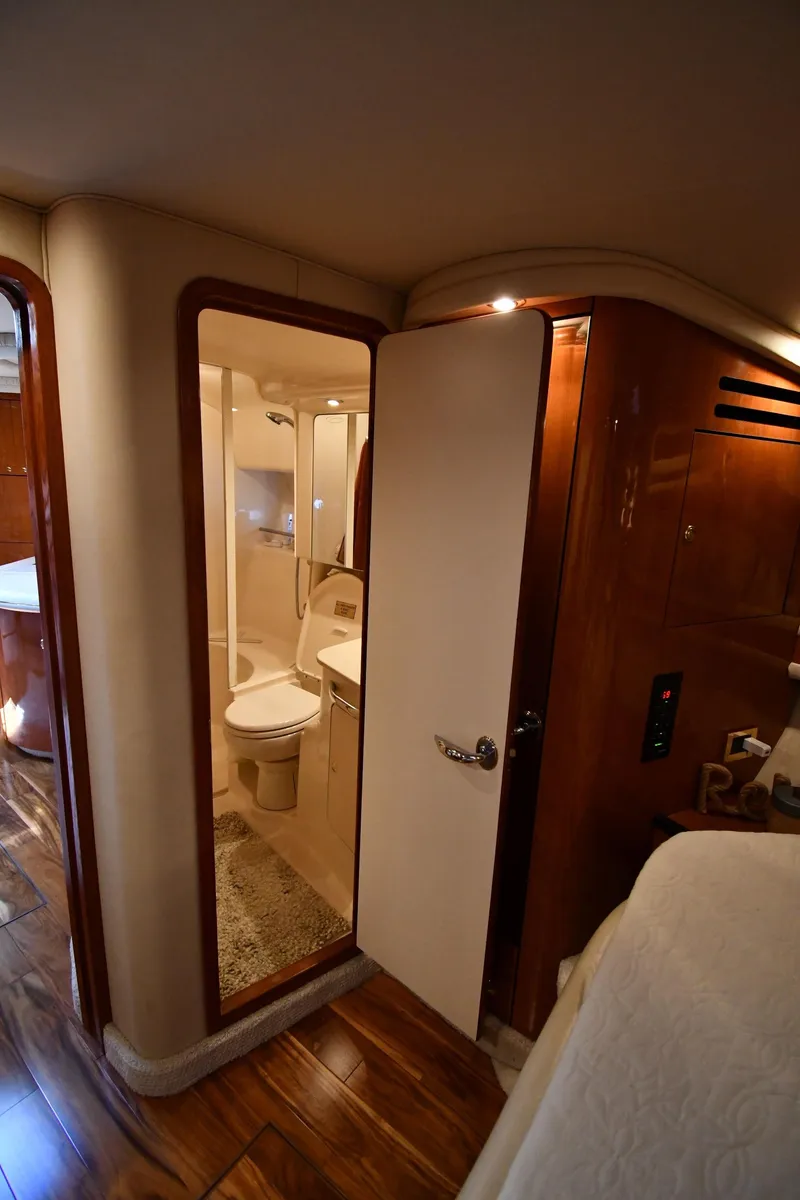 Slide: The Image of Interior of a 2000 Sea Ray Sundancer 460 featuring a bathroom and wooden flooring. - 41