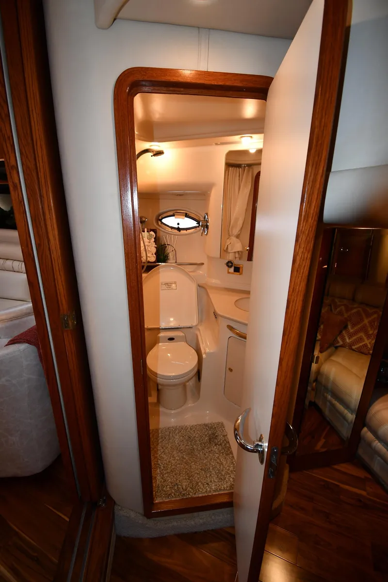 Slide: The Image of View into a boat bathroom with toilet, sink, and mirror. - 42