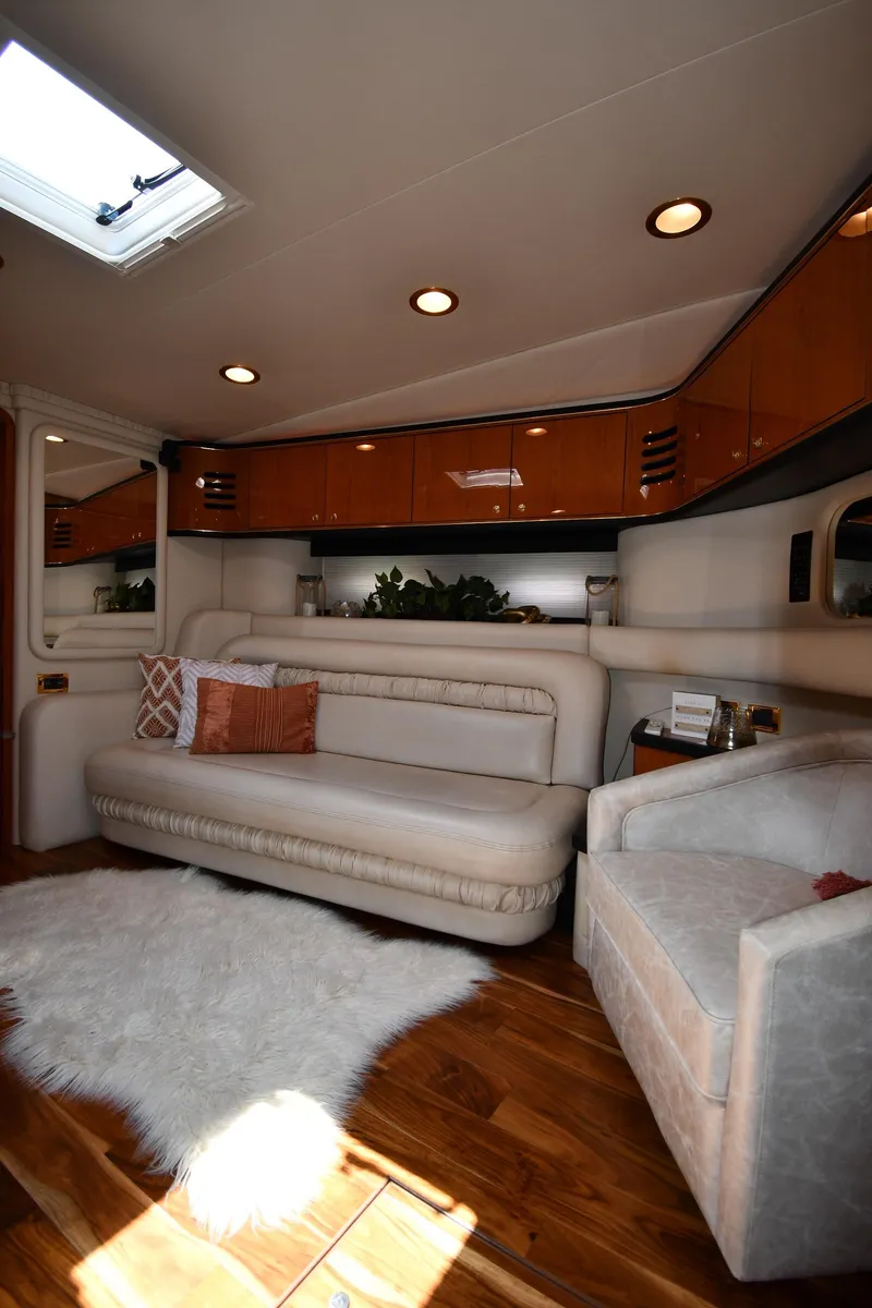 Slide: The Image of Interior of the 2000 Sea Ray Sundancer 460 with elegant seating area and wooden floor. - 46