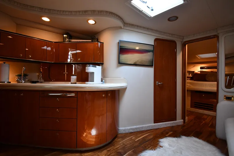 Slide: The Image of Interior of the 2000 Sea Ray Sundancer 460 with elegant wood finishes and cozy ambiance. - 47