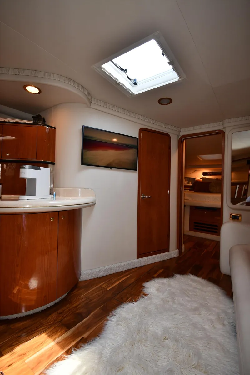 Slide: The Image of Interior of a 2000 Sea Ray Sundancer 460 with wood flooring and a rug. - 48