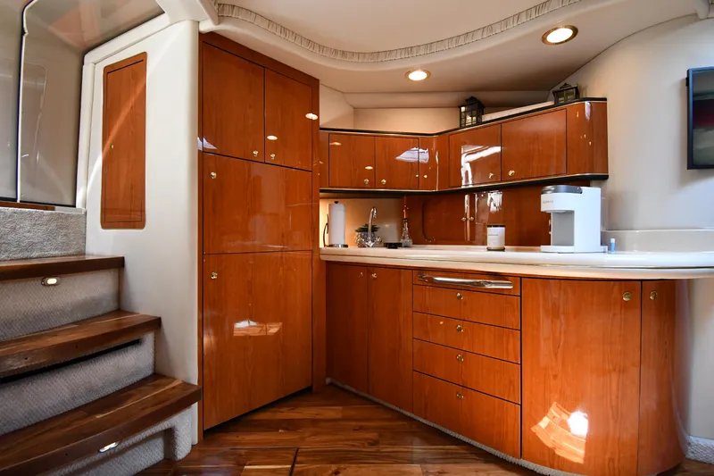 Slide: The Image of Interior of a 2000 Sea Ray Sundancer 460 with elegant wooden cabinetry. - 49