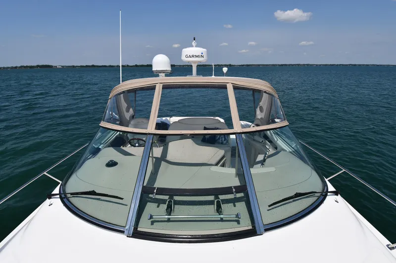 Slide: The Image of A 2000 Sea Ray Sundancer 460 on calm water with a clear sky. - 7