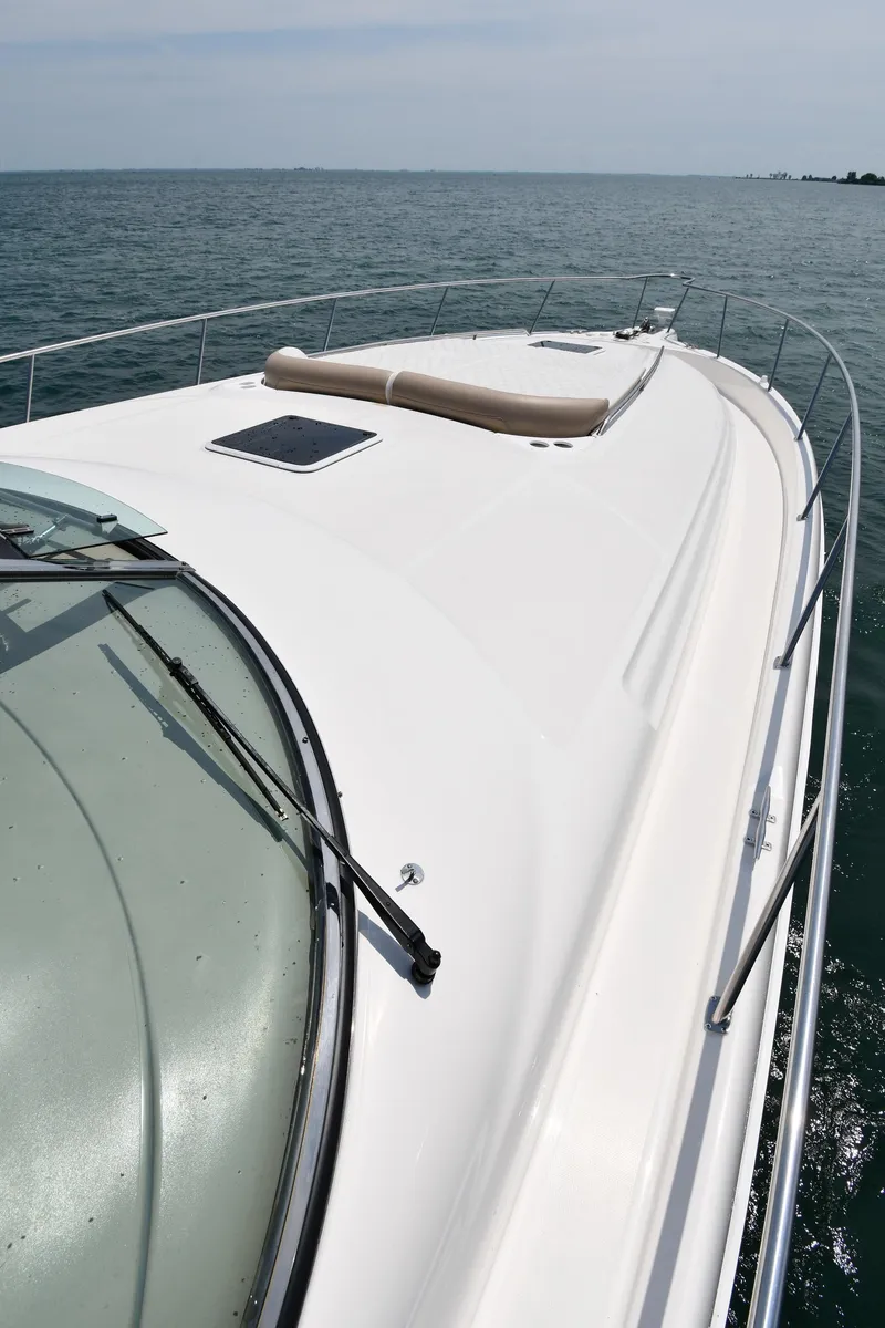 Slide: The Image of The deck of a 2000 Sea Ray Sundancer 460 on calm water. - 9