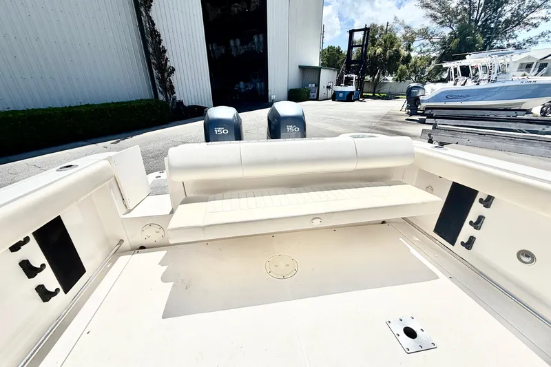 Slide: The Image of 2012 Robalo R247 Dual Console boat with Yamaha 150 engines, docked outdoors. - 12