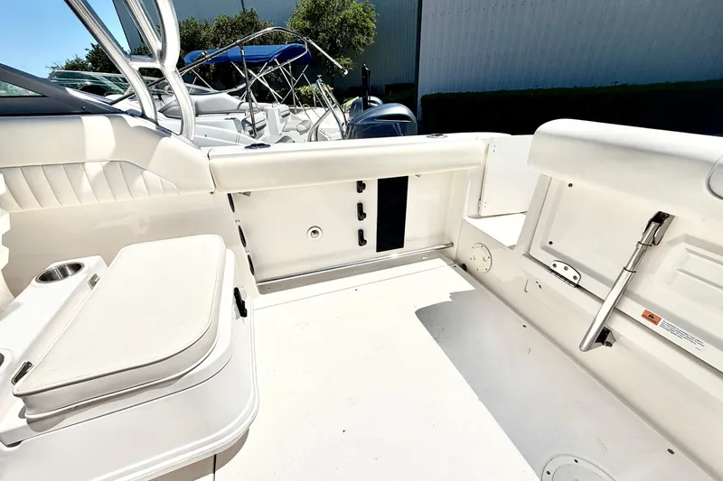 Slide: The Image of 2012 Robalo R247 Dual Console boat interior with seating and storage compartments. - 13