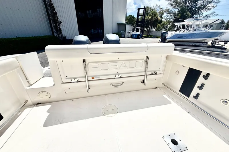 Slide: The Image of 2012 Robalo R247 Dual Console boat interior, showcasing spacious deck and seating area. - 14