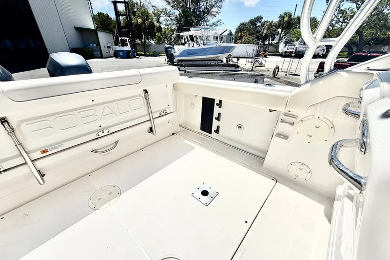 Slide: The Image of 2012 Robalo R247 Dual Console boat interior, featuring spacious seating and storage compartments. - 15