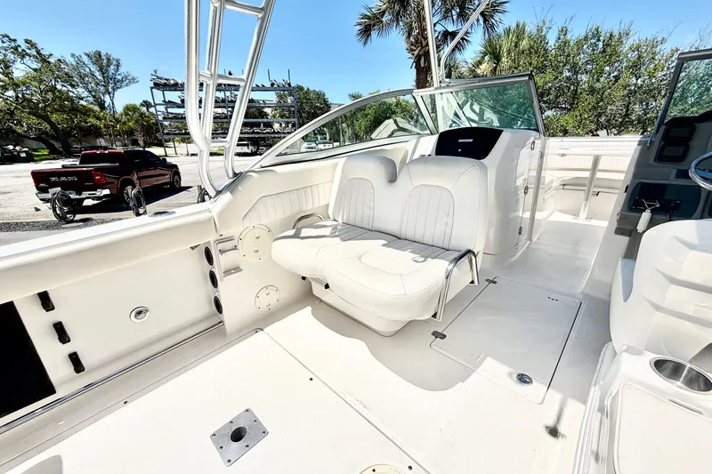 Slide: The Image of 2012 Robalo R247 Dual Console boat interior with white seating and open deck. - 16