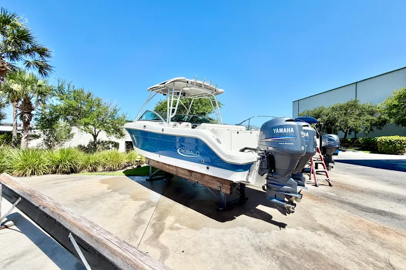 Slide: The Image of 2012 Robalo R247 Dual Console boat with Yamaha engines on a sunny day. - 3