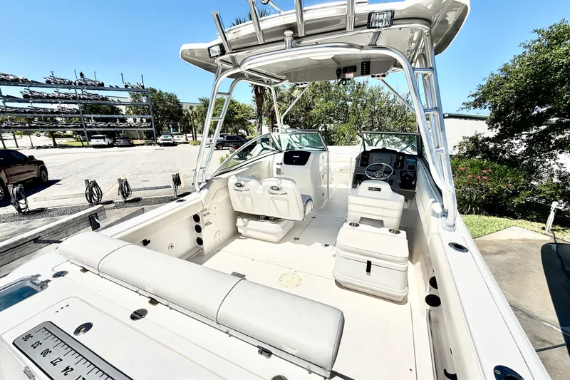 Slide: The Image of 2012 Robalo R247 Dual Console boat interior with seating and steering console. - 9