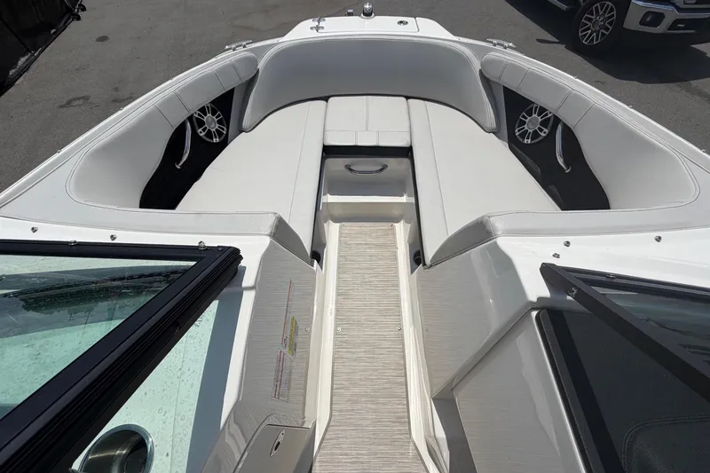 Slide: The Image of The image shows the cockpit of a Sea Ray SPX 210 Outboard boat with white upholstery. - 27