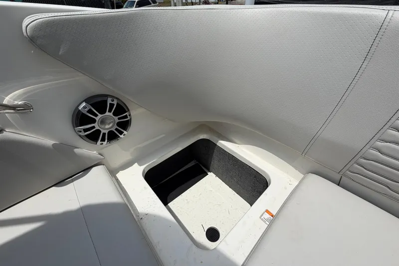 Slide: The Image of 2023 Sea Ray SPX 210 Outboard interior with speaker and storage compartment. - 52