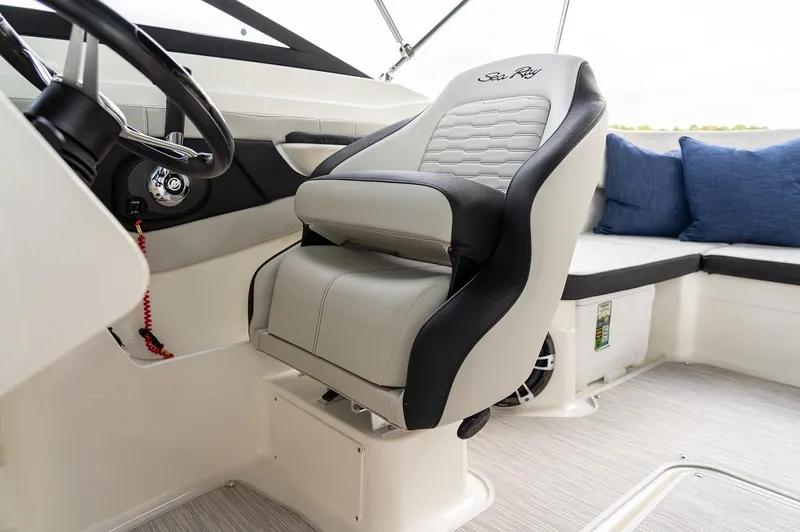 Slide: The Image of Manufacturer Provided Image: 2023 Sea Ray SPX 210 OB boat interior with captain's chair and seating area. - 13