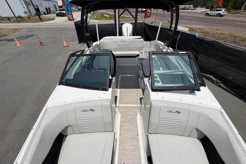 Slide: The Image of 2023 Sea Ray SPX 210 Outboard boat interior with white seating and open deck layout. - 37