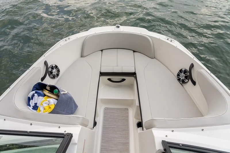 Slide: The Image of Manufacturer Provided Image: 2023 Sea Ray SPX 210 OB boat interior with cushioned seating and water view. - 15