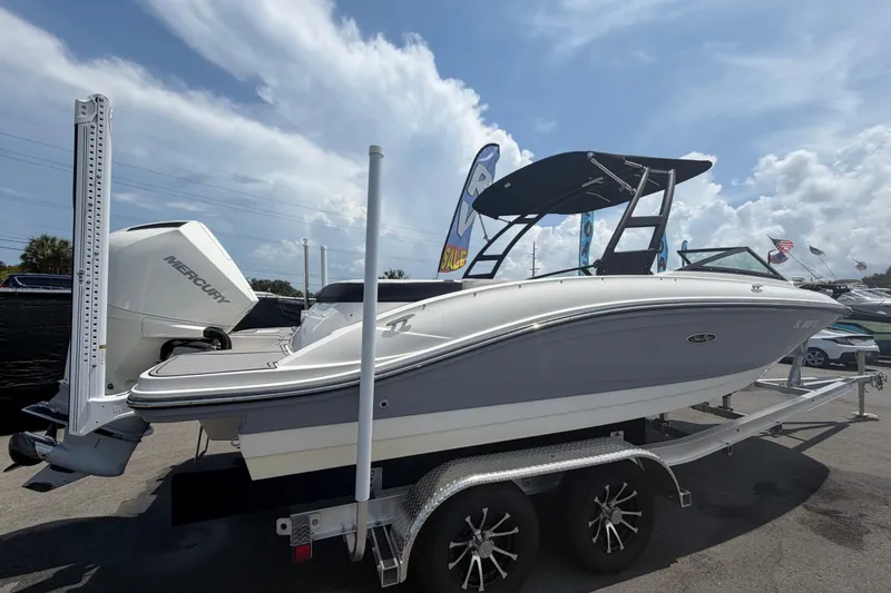 Slide: The Image of 2023 Sea Ray SPX 210 Outboard boat on trailer, featuring sleek design and Mercury engine. - 2