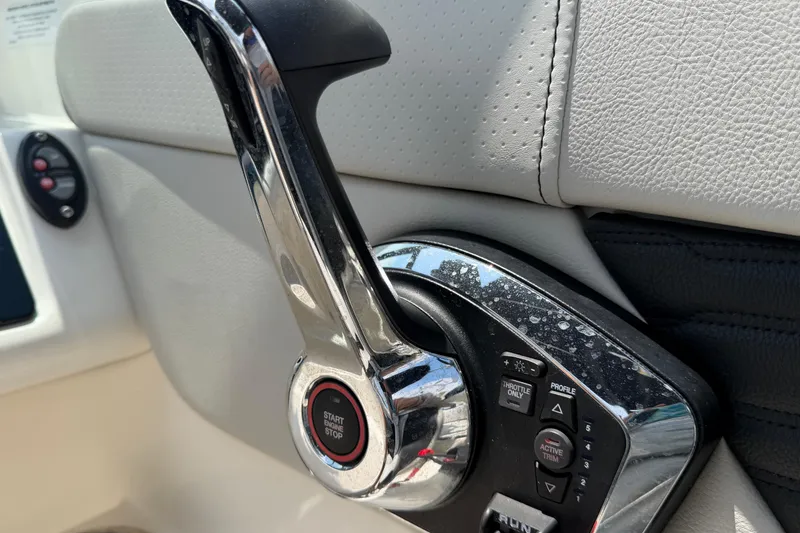 Slide: The Image of Close-up of 2023 Sea Ray SPX 210 Outboard throttle control with start/stop button. - 22