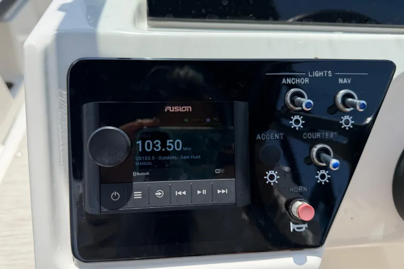 Slide: The Image of Control panel of 2023 Sea Ray SPX 210 Outboard with Fusion audio system and light switches. - 20