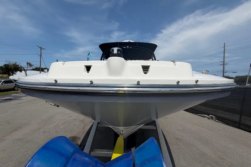 Slide: The Image of 2023 Sea Ray SPX 210 Outboard boat on trailer, front view under clear sky. - 8