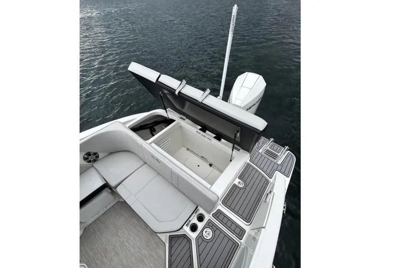 Slide: The Image of The image shows the deck of a 2023 Sea Ray SPX 210 Outboard boat on the water. - 3
