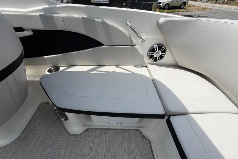 Slide: The Image of 2023 Sea Ray SPX 210 Outboard boat interior with white seating and speaker. - 48