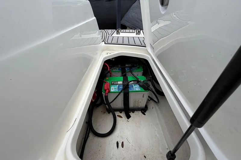 Slide: The Image of Battery compartment of 2023 Sea Ray SPX 210 Outboard boat, showcasing dual batteries. - 59