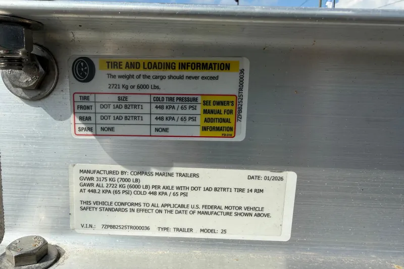 Slide: The Image of Tire and loading information label on a 2023 Sea Ray SPX 210 Outboard trailer. - 67