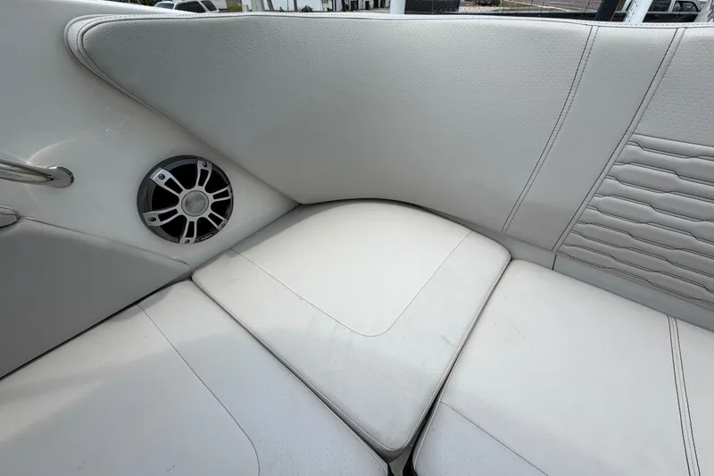 Slide: The Image of 2023 Sea Ray SPX 210 Outboard boat interior with white seating and speaker detail. - 51