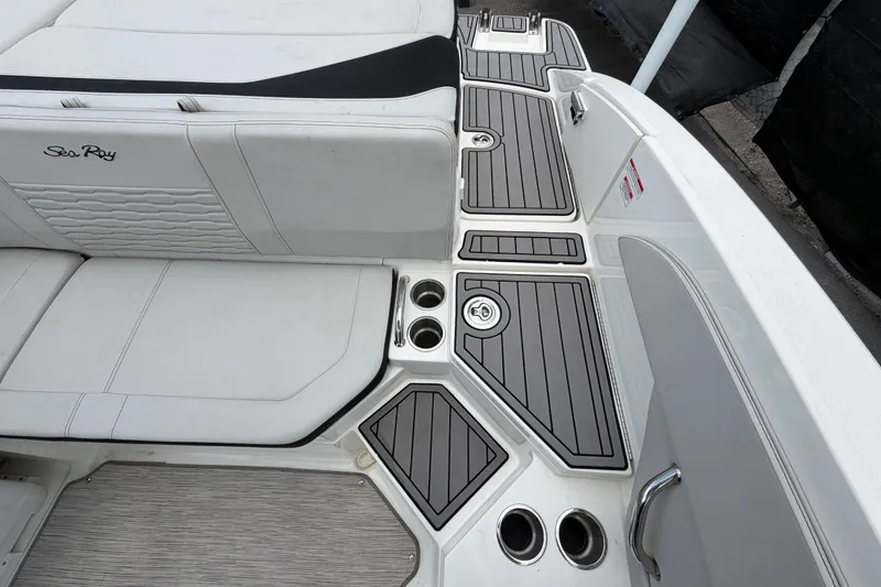 Slide: The Image of 2023 Sea Ray SPX 210 Outboard boat interior with sleek seating and cup holders. - 55