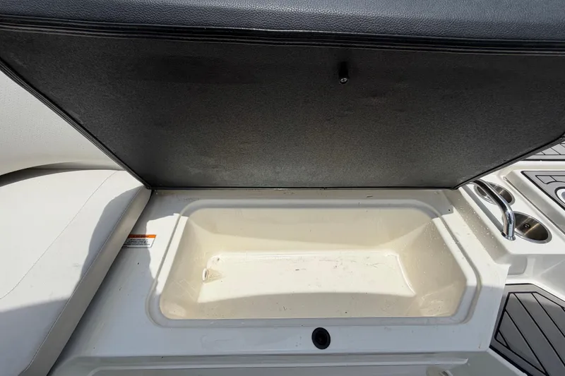 Slide: The Image of Open storage compartment on 2023 Sea Ray SPX 210 Outboard boat. - 54