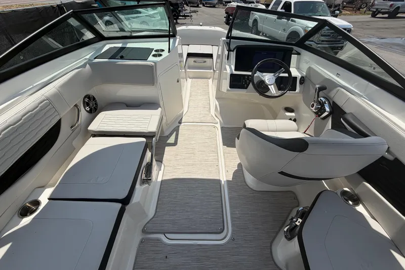 Slide: The Image of 2023 Sea Ray SPX 210 Outboard boat interior with sleek seating and modern dashboard. - 15