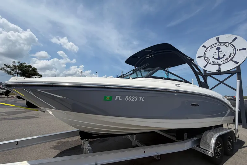 Slide: The Image of 2023 Sea Ray SPX 210 Outboard boat on trailer under clear sky. - 7