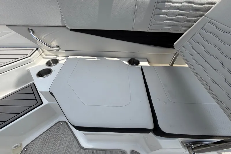 Slide: The Image of 2023 Sea Ray SPX 210 Outboard boat interior with cushioned seating and cup holders. - 43