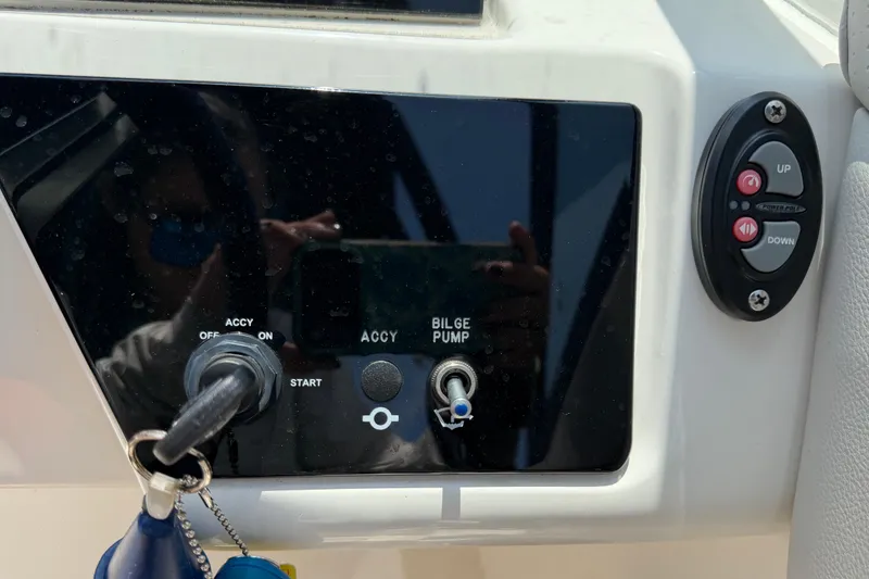 Slide: The Image of Control panel of a 2023 Sea Ray SPX 210 Outboard boat with ignition and bilge pump switches. - 21