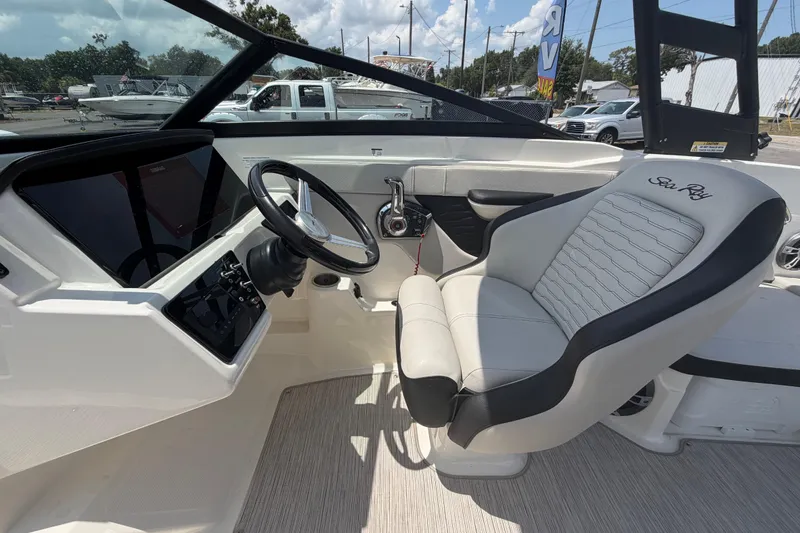 Slide: The Image of 2023 Sea Ray SPX 210 Outboard cockpit with steering wheel and comfortable seating. - 17