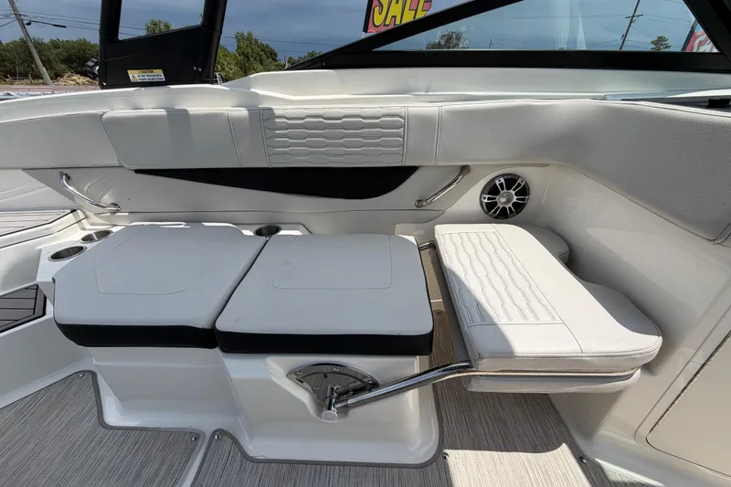 Slide: The Image of 2023 Sea Ray SPX 210 Outboard interior with white seating and cup holders. - 41