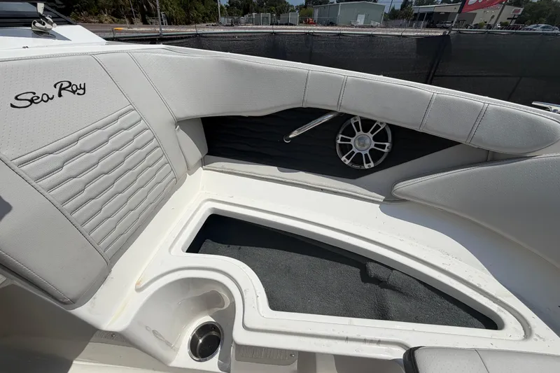 Slide: The Image of 2023 Sea Ray SPX 210 Outboard boat interior with white seating and speaker detail. - 30
