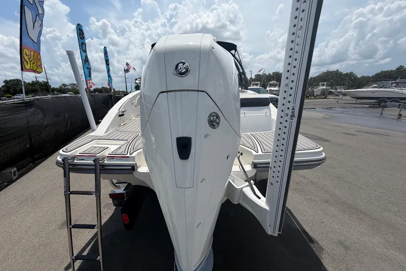 Slide: The Image of 2023 Sea Ray SPX 210 Outboard boat displayed at a marina with flags and clear skies. - 3