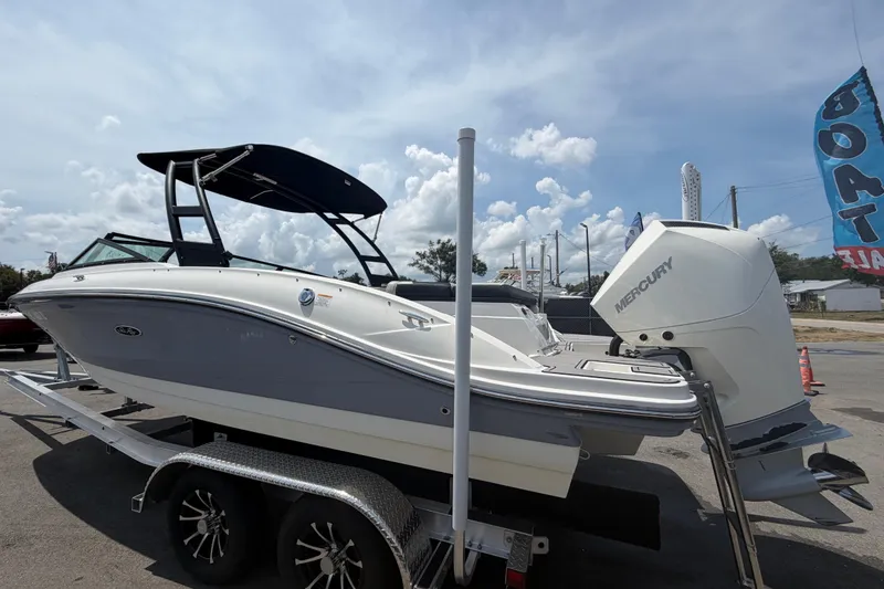 Slide: The Image of 2023 Sea Ray SPX 210 Outboard boat on trailer, featuring Mercury engine, under clear sky. - 5