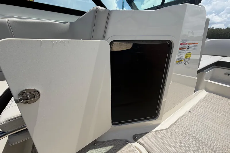 Slide: The Image of Open storage compartment on 2023 Sea Ray SPX 210 Outboard boat interior. - 25