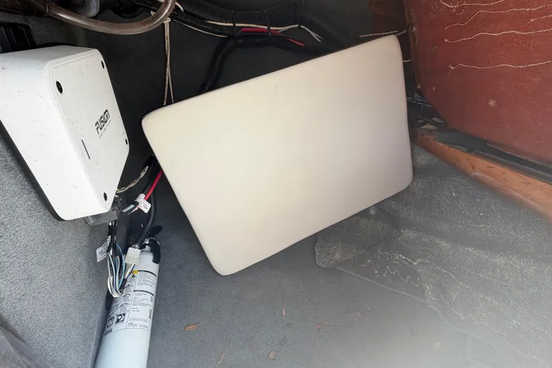 Slide: The Image of Interior view of a 2023 Sea Ray SPX 210 Outboard boat compartment with wiring and equipment. - 26